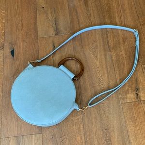 Light blue, round, crossbody bag. NEVER WORN